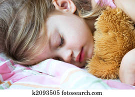 Child sleeping with Teddy
