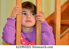 Sad girl looks at here fighting parents Sad girl looks at here fighting parents