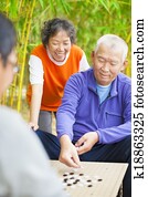 seniors play traditional chinese board game Go