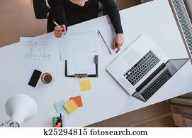 Woman reviewing financial data and plotting progress