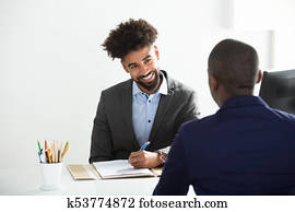 Businessman Interviewing Male Candidate