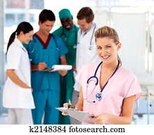 Blonde nurse with her team in the background