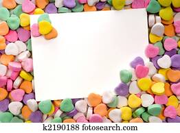 Blank note card surrounded, framed by candy hearts