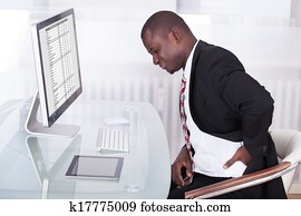 Businessman Suffering From Back Pain Businessman Suffering From Back Pain