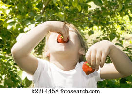 Girl eating strawberries. 