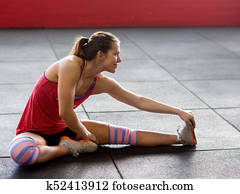 Woman Doing Stretching Exercise In Gym