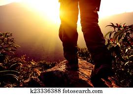 woman hiker stand on mountain peak 