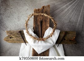 Easter background depicting the crucifixion with a rustic wooden cross, crown of thorns and nails.
