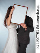 Bride and groom with a frame for photos Bride and groom with a frame for photos