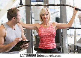 Personal Trainer Watching Woman Weight Train Personal Trainer Watching Woman Weight Train
