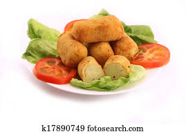 Potato croquettes over vegetables salad