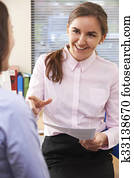 Businesswoman In Conversation With Female Intern