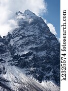Clouds over rocky unclimbed Peak 5939, Himalaya