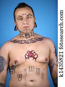 Man with tattoos and piercings.