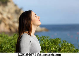 Woman breathing fresh air relaxed on vacation Woman breathing fresh air relaxed on vacation