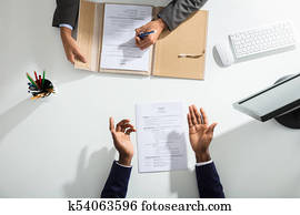 Businessperson And Candidates Hand Over White Desk