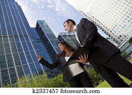 Happy Mixed Race Businessman and Businesswoman Team In the City
