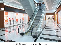 Persons on escalator in shop Persons on escalator in shop