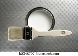 Painter brush and white paint tin