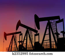 Three oil wells in the desert at dusk Three oil wells in the desert at dusk