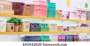 A lot of plastic household goods for home and everyday life, colorful products on the shelf of a store window, containers, buckets, storage baskets, basins A lot of plastic household goods for home and everyday life, colorful products on the shelf of a store window, containers, buckets, storage baskets, basins
