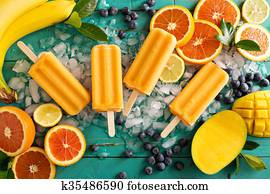 Mango banana popsicles on ice Mango banana popsicles on ice