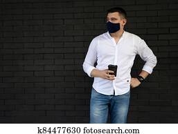 Businessman near office in protective cloth face mask