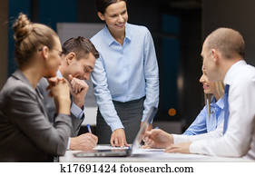 smiling female boss talking to business team smiling female boss talking to business team