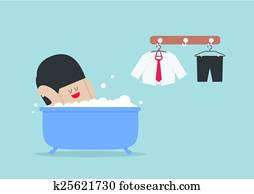 Businessman taking a bath and relaxing in bathtub