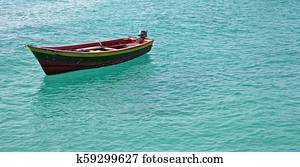 colorful wooden fishing boat on a turquoise ocean
