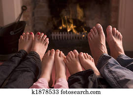 Family of feet warming at a fireplace Family of feet warming at a fireplace