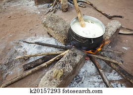 Preparing banku on a fire, Africa