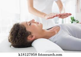 Woman having reiki treatment Woman having reiki treatment