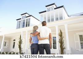 Young Couple Standing Outside Dream Home Young Couple Standing Outside Dream Home