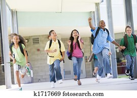 Six students running away from front door of school excited Six students running away from front door of school excited