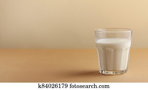 Banner of a glass of milk on a brown background. The concept of farm dairy products, the use of milk. Copy space. Banner of a glass of milk on a brown background. The concept of farm dairy products, the use of milk. Copy space.