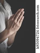  Praying hands with faith in religion and belief in God on dark background. Pay respect. Namaste or Namaskar hands gesture.
