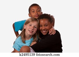 Portrait of three children, two girls and one boy of mixed ethnicity