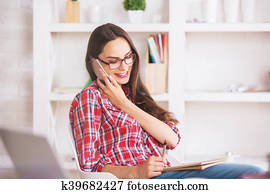 Woman on phone taking notes