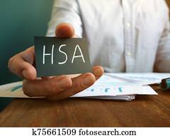 Hand holds Health Savings Accounts HSA inscription. Hand holds Health Savings Accounts HSA inscription.