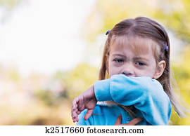 Coughing or sneezing into arm