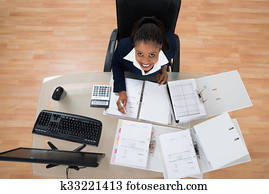 Businesswoman Calculating Bills