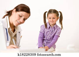 Female doctor write prescription for child