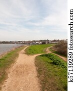 long walkway trail at side of bay of water uk manningtree nature background