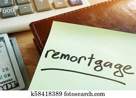 Remortgage concept. Memo stick, calculator and money.