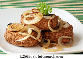 rissole with grilled organic onion and parsley on a plate