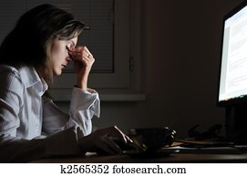 Tired business person with headache working at night