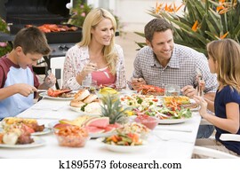 Family Enjoying A Barbeque Family Enjoying A Barbeque