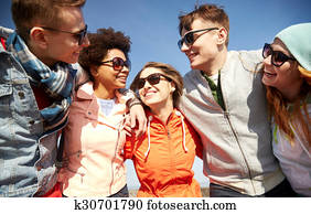 smiling friends in sunglasses laughing on street smiling friends in sunglasses laughing on street