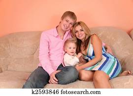 young family on sofa in pink room 2 young family on sofa in pink room 2